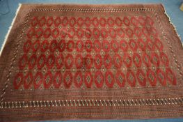 A TEKKE BOKHARA RED GROUND RUG, 320cm x 250cm (Sd to tassels)