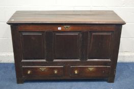 A GEORGIAN OAK COFFER, with a plank top and triple fielded panel front, above two drawers with brass