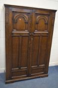 A CARVED OAK DOUBLE DOOR WARDROBE, width 127cm x depth 53cm x height 187cm (key)