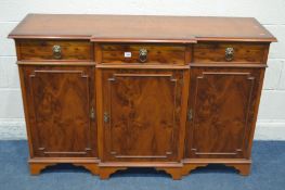 A YEWWOOD BREAKFRONT SIDEBOARD with three drawers, width 139cm x depth 46cm x height 90cm (three