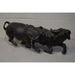 A HARDWOOD CARVING OF TWO WATER BUFFALO'S STAMPEDING, carved from a single piece of wood, losses and