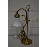 A BRASS SINGLE BRANCH ADJUSTABLE TABLE LIGHT, with a shaped white glass shade