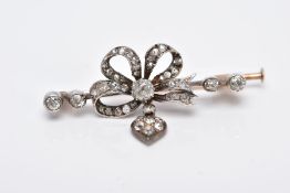 A LATE VICTORIAN GOLD DIAMOND RIBBON BOW BAR BROOCH, diamond encrusted tied bow top suspending a