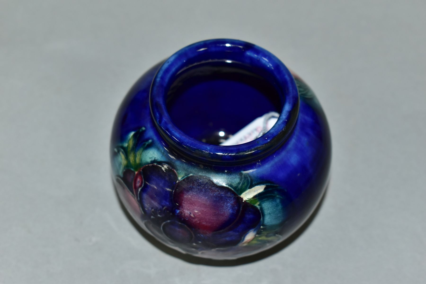 A MOORCROFT POTTERY SQUAT GLOBULAR VASE DECORATED WITH PURPLE/PINK ANEMONE, on a blue ground, - Image 4 of 5