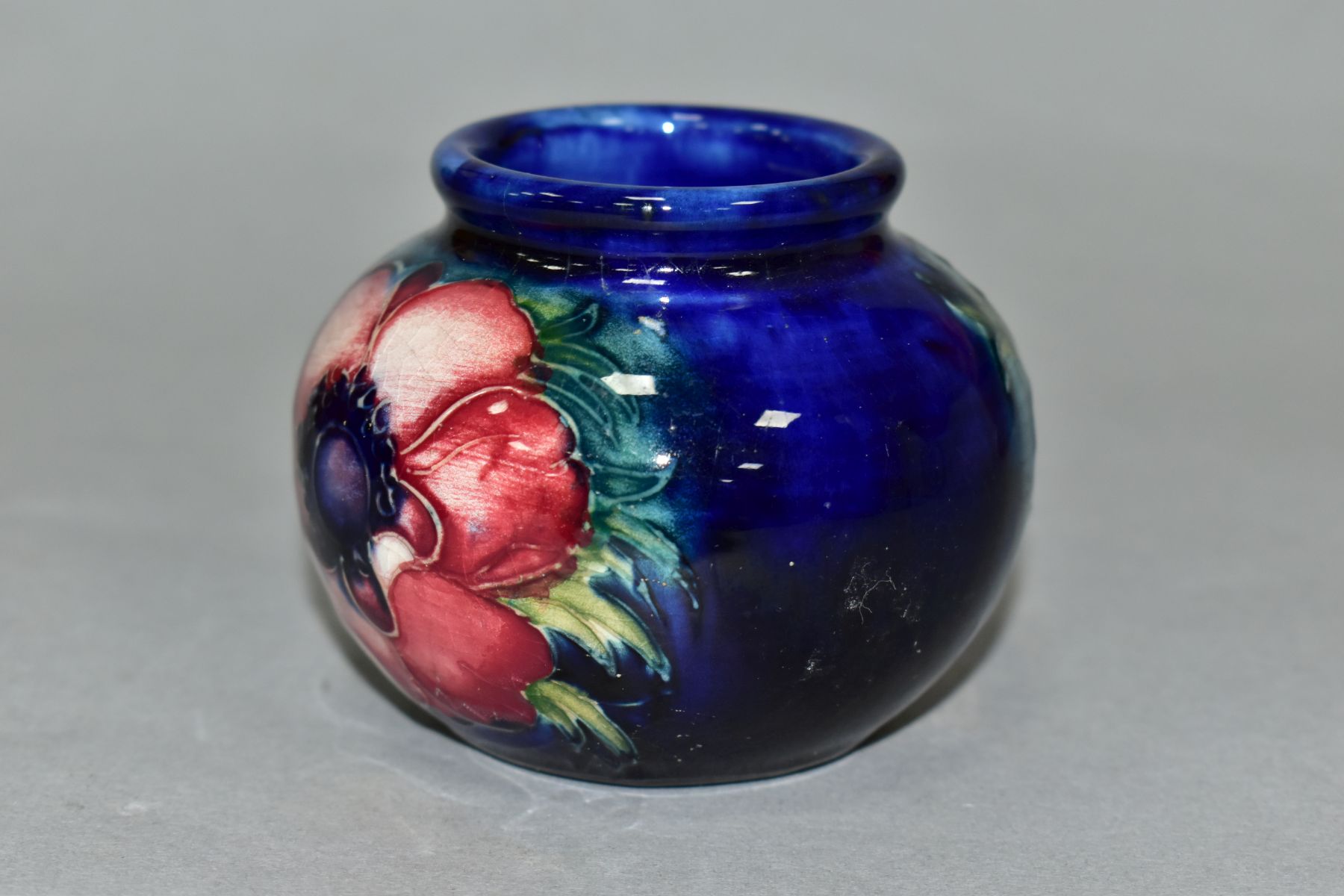 A MOORCROFT POTTERY SQUAT GLOBULAR VASE DECORATED WITH PURPLE/PINK ANEMONE, on a blue ground, - Image 2 of 5