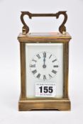 A BRASS FRAMED CARRIAGE CLOCK, four glass panels, white dial, roman numerals, approximate height
