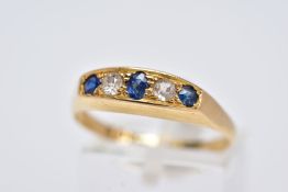 AN 18CT GOLD FIVE STONE RING, of a boat shape, set with a central oval cut blue sapphire interspaced