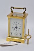 A REPRODUCTION CALENDAR CARRIAGE CLOCK with moon phase, the striking and repeating movement with