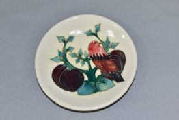 A MOORCROFT POTTERY PIN DISH DECORATED IN THE FINCH AND PLUM TREE PATTERN, designed by Sally Tuffin,