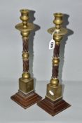 A PAIR OF LATE 19TH/EARLY 20TH CENTURY BRASS AND BROWN BAKELITE CANDLESTICKS, spiral twist moulded
