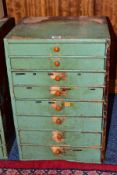 A LATE 19TH CENTURY PINE BANK OF EIGHT GRADUATED DRAWERS, partially painted green, all draws with