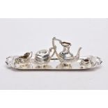 A MINIATURE FIVE PIECE SILVER TEA SET, comprising of teapot with cover, coffee pot missing cover,