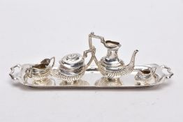 A MINIATURE FIVE PIECE SILVER TEA SET, comprising of teapot with cover, coffee pot missing cover,