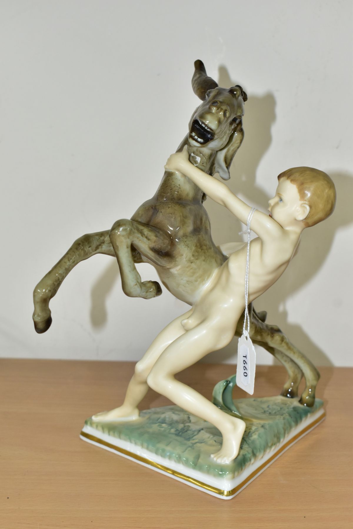 A 20TH CENTURY SELB HUTSCHENREUTHER FIGURE GROUP OF A DONKEY FOAL AND A SPRITE, on a triangular base