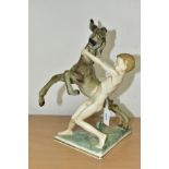 A 20TH CENTURY SELB HUTSCHENREUTHER FIGURE GROUP OF A DONKEY FOAL AND A SPRITE, on a triangular base
