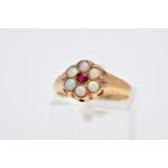 A YELLOW METAL OPAL AND GARNET CLUSTER RING, designed with a central circular cut garnet, within a