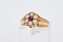 A YELLOW METAL OPAL AND GARNET CLUSTER RING, designed with a central circular cut garnet, within a