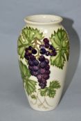 A MOORCROFT POTTERY COLLECTORS CLUB GRAPEVINE PATTERN BALUSTER VASE, on a cream ground, designed