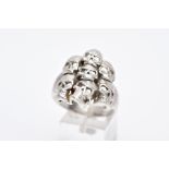 A GENTS SILVER SKULL RING, large ring designed with seven openwork skulls, stamped '925' Birmingham,