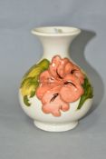 A MOORCROFT POTTERY SQUAT BALUSTER VASE DECORATED WITH CORAL HIBISCUS, cream ground, gilt sticker to