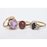 THREE 9CT GOLD GEM SET RINGS, to include an oval cut amethyst set with an openwork scallop edge