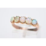 A YELLOW METAL FIVE STONE OPAL RING, designed with a row of five circular cut opal cabochons,