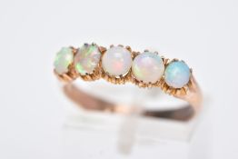 A YELLOW METAL FIVE STONE OPAL RING, designed with a row of five circular cut opal cabochons,