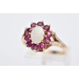 A 9CT GOLD OPAL AND RUBY CLUSTER RING, designed with a central oval cut opal, within a surround of