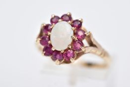 A 9CT GOLD OPAL AND RUBY CLUSTER RING, designed with a central oval cut opal, within a surround of