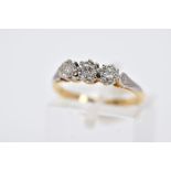 A YELLOW METAL THREE STONE DIAMOND RING, designed with three illusion set diamonds, two old cut