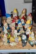 A COLLECTION OF PLASTER AND ONE TERRACOTTA GARDEN GNOMES, including two of teapot and cover form,