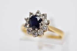 AN 18CT GOLD, SAPPHIRE AND DIAMOND CLUSTER RING, designed with a central oval cut blue sapphire,