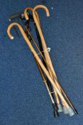 A SMALL BUNDLE OF 20TH CENTURY WALKING STICKS and a thin bamboo cane with riveted metal handle,