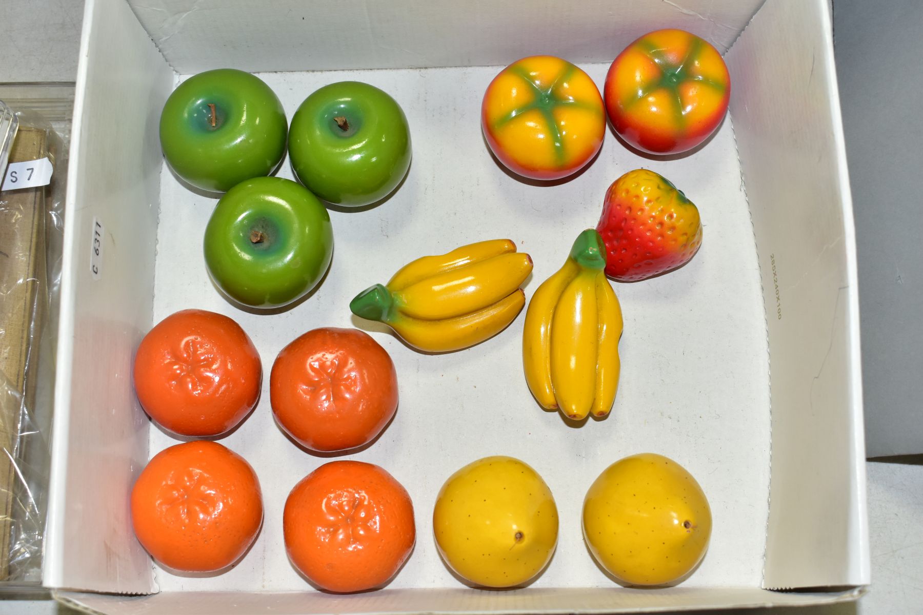 A BOX OF NOVELTY PENCIL SHARPENERS IN THE FORM OF FRUIT, the painted plaster fruit modelled as