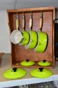 LE CREUESET, a set of four lime green graduated saucepans with lids, comprising sizes 14, 16, 20 and