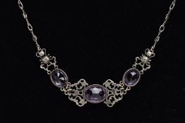 AN ARTS AND CRAFTS AMETHYST NECKLACE, designed with three collet set, oval mix cut amethysts,
