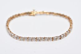 A 9CT DIAMOND LINE BRACELET, designed with a row of individual claw set, single cut diamonds,