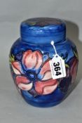 A MOORCROFT POTTERY GINGER JAR AND COVER, DECORATED WITH PURPLE/PINK ANEMONE, on a blue ground,