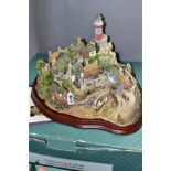 A BOXED LIMITED EDITION LILLIPUT LANE SCULPTURE, 'Out of the Storm' L2064, No 0662/3000, on a wooden