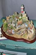A BOXED LIMITED EDITION LILLIPUT LANE SCULPTURE, 'Out of the Storm' L2064, No 0662/3000, on a wooden
