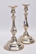 A PAIR OF LATE 19TH/EARLY 20TH CENTURY CONTINENTAL WHITE METAL CANDLESTICKS, engine turned and