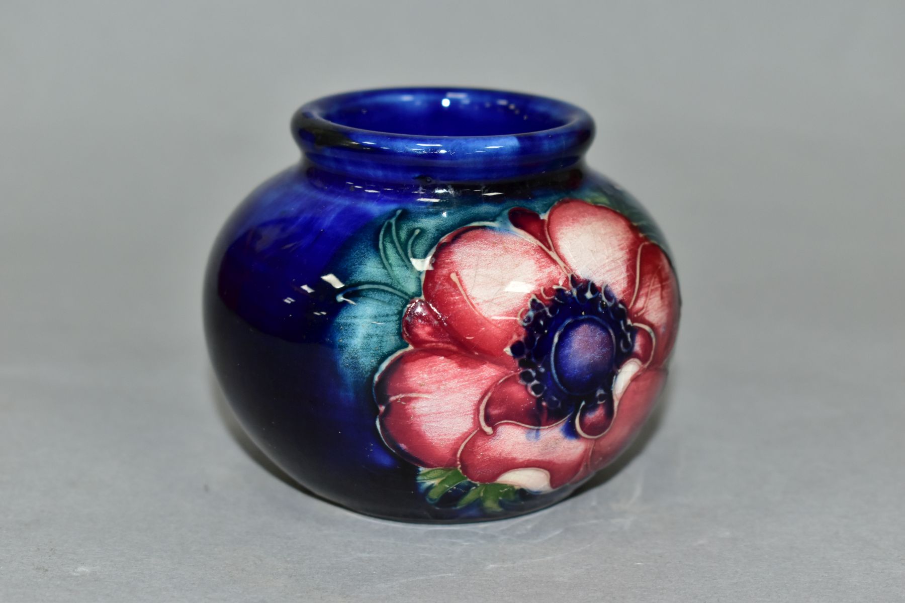 A MOORCROFT POTTERY SQUAT GLOBULAR VASE DECORATED WITH PURPLE/PINK ANEMONE, on a blue ground, - Image 3 of 5