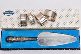 FOUR SILVER NAPKIN RINGS AND A SILVER HANDLED PIE SERVER, to include four modern napkin rings with