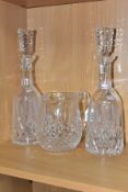 THREE PIECES OF WATERFORD CRYSTAL IN THE LISMORE PATTERN, comprising a pair of decanters and