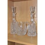 THREE PIECES OF WATERFORD CRYSTAL IN THE LISMORE PATTERN, comprising a pair of decanters and