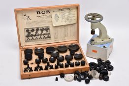 A WORK BENCH PRESS AND A NEAR COMPLETE CASED SET OF 'ROBUR' WATCH GLASS PRESS ATTACHMENTS, also