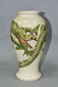 A MOORCROFT POTTERY CREAM GROUND VASE DECORATED WITH A GREEN DRAGON, painted WM and impressed
