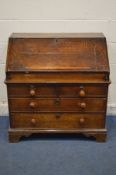 A GEORGIAN AND LATER OAK BUREAU, the fall front with a moulded bookrest, enclosing a fitted interior