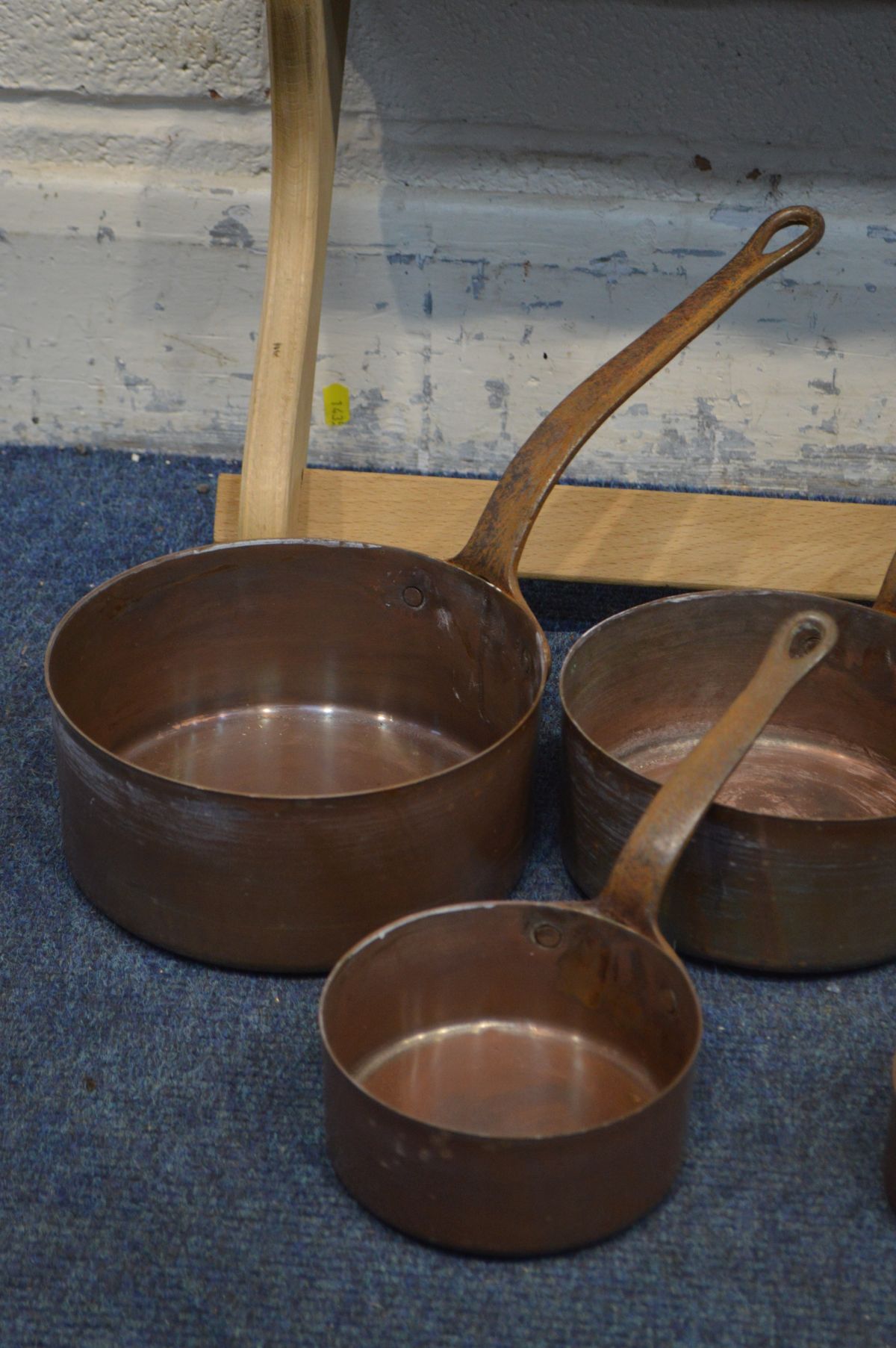 A SET OF FIVE COPPER GRADUATED PANS with hooped iron handles, and a pine hanging wall rack ( - Image 2 of 2