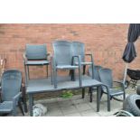 A BLACK PLASTIC GARDEN TABLE, 164cm wide 93cm deep, six matching chairs (stamped Allibert) and two